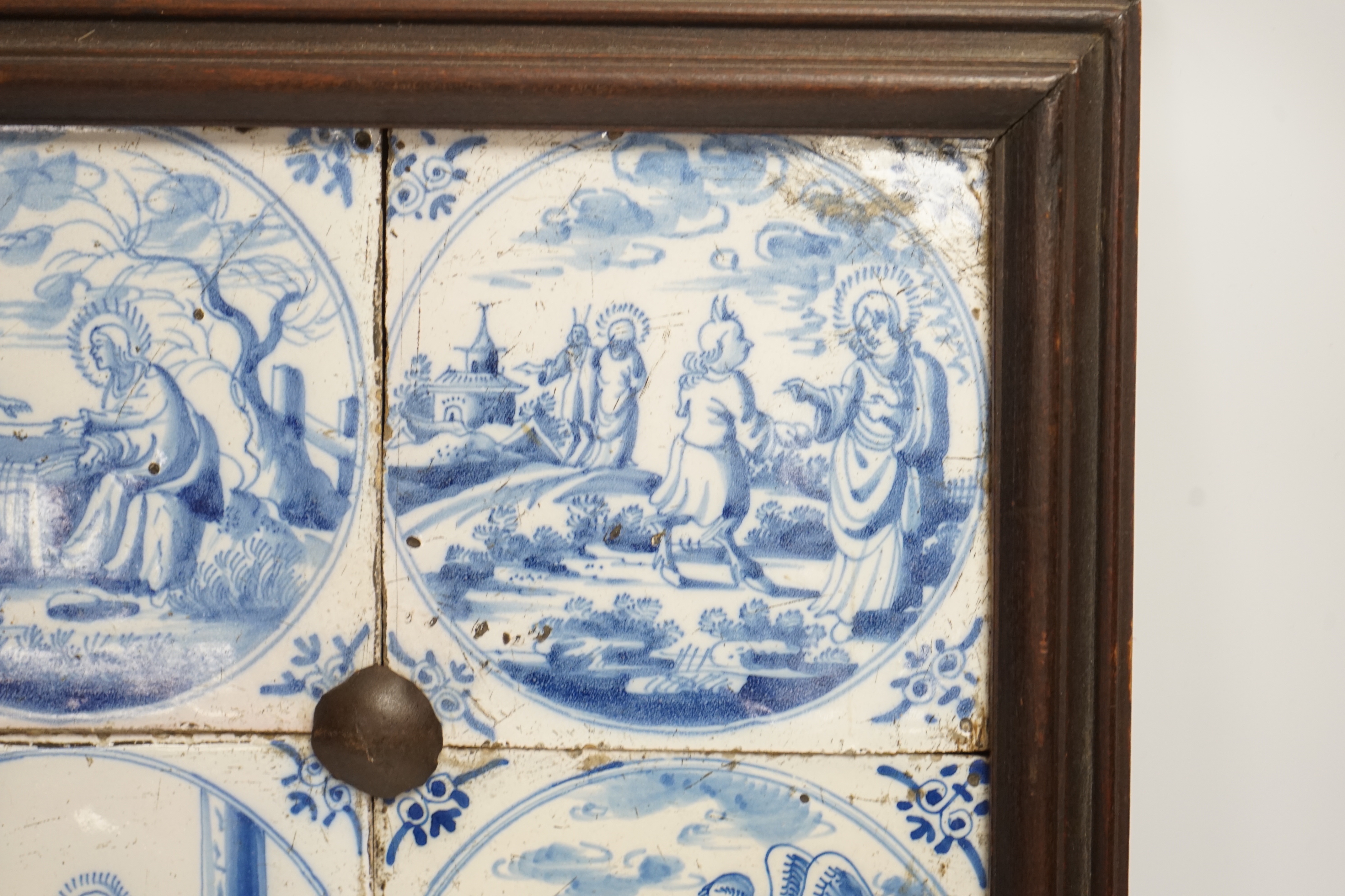 Four framed 19th century Delft ‘bible story’ tiles, 31cm x 31cm